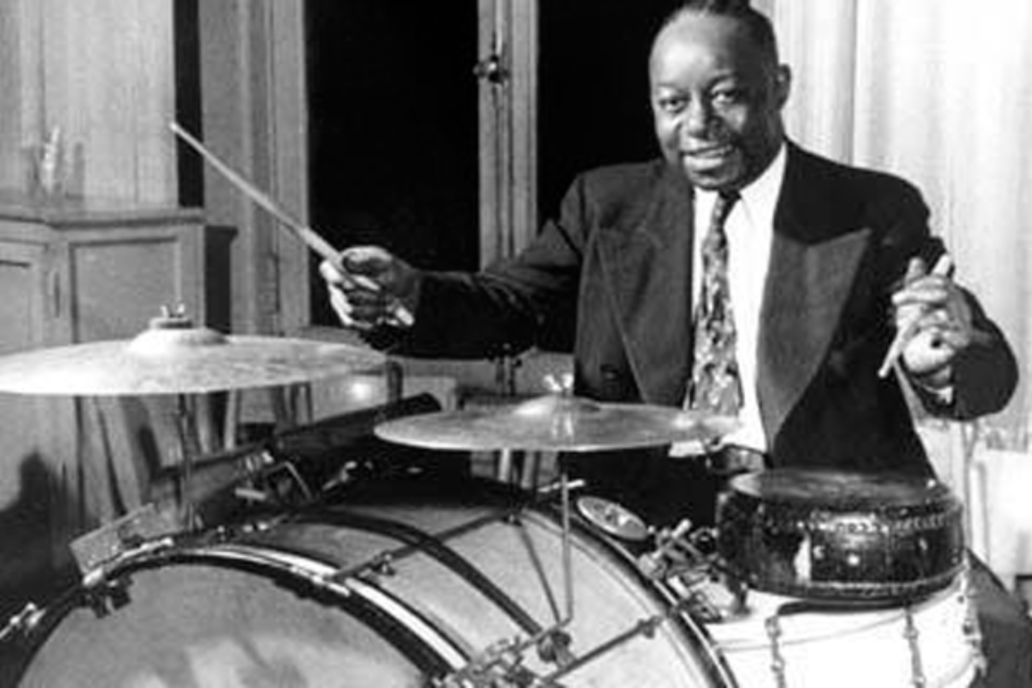 Baby Dodds sitting behing his jazz drumset