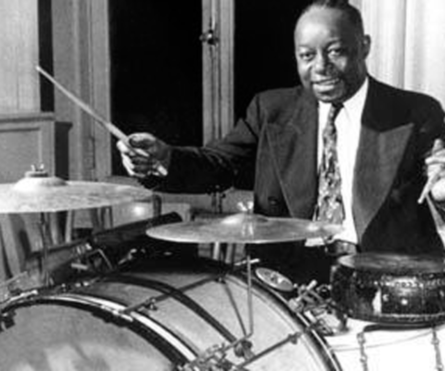 Baby Dodds sitting behing his jazz drumset